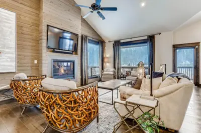 a living room with furniture and a fireplace at River Run Townhome RR51 in Keystone