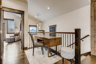 a home office with a desk and a balcony at River Run Townhome RR51 in Keystone