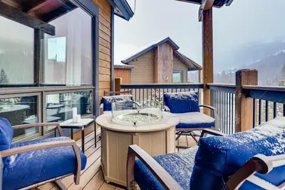 a deck with a table and chairs on a balcony at River Run Townhome RR51 in Keystone