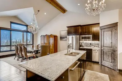 a kitchen and dining room with a table and chairs at River Run Townhome RR51 in Keystone