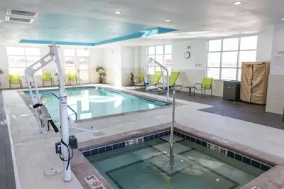 a swimming pool in a large room with a pool at Hampton Inn & Suites Lafayette in Lafayette