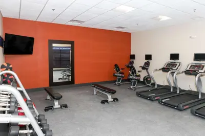 a gym with a bunch of cardio equipment in a room at Hampton Inn & Suites Lafayette in Lafayette