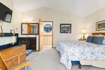 a bedroom with a bed and a tv and a sink at Mountainside 523 Home in Frisco