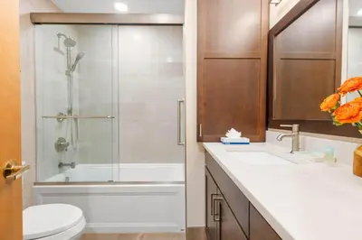a bathroom with a shower and a toilet and a sink at Mountainside 523 Home in Frisco