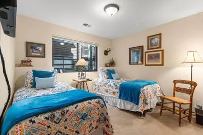a bedroom with two beds and a chair and a window at Mountainside 523 Home in Frisco