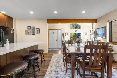 a kitchen and dining room with a table and chairs at Mountainside 523 Home in Frisco