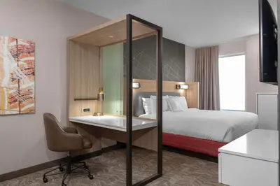 a hotel room with a bed and a desk with a computer at SpringHill Suites by Marriott Denver Tech Center in Greenwood Village