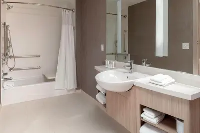 a bathroom with a sink and a tub and a toilet at SpringHill Suites by Marriott Denver Tech Center in Greenwood Village