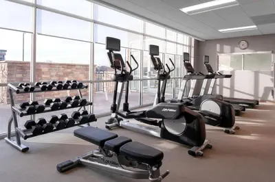 a gym with a row of treadmills and machines at SpringHill Suites by Marriott Denver Tech Center in Greenwood Village