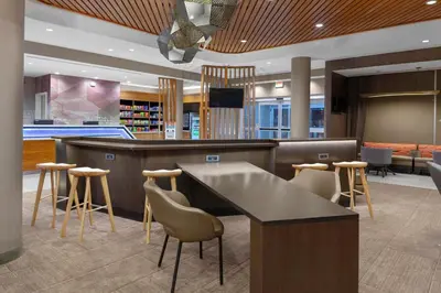 a lobby with a bar and stools in a library at SpringHill Suites by Marriott Denver Tech Center in Greenwood Village