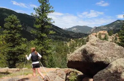 a woman is standing on top of a mountain at Stonebrook Resort - Adult Only in Estes Park