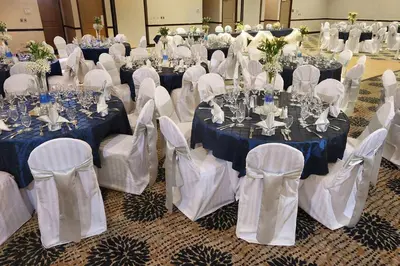 a room full of tables and chairs with blue and white table settings at DoubleTree by Hilton Hotel Denver - Thornton in Thornton