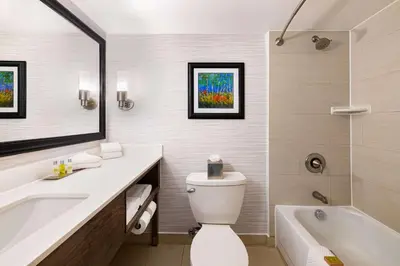 a bathroom with a tub and a toilet and a sink at DoubleTree by Hilton Hotel Denver - Thornton in Thornton