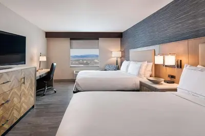 a hotel room with two beds and a flat screen tv at DoubleTree by Hilton Hotel Denver - Thornton in Thornton