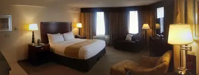 a hotel room with a bed and a chair at DoubleTree by Hilton Hotel Denver - Thornton in Thornton