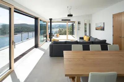 a living room with a couch and a table at Timberline Haus Home in Nederland