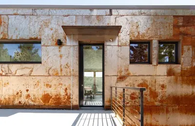 an old building with a door and windows at Timberline Haus Home in Nederland