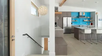 a kitchen with a sink and a kitchen with blue at Timberline Haus Home in Nederland