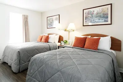 a hotel room with two beds and a window at InTown Suites Extended Stay Denver - Englewood in Englewood