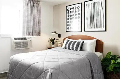 a bedroom with a bed and a window at InTown Suites Extended Stay Denver - Englewood in Englewood