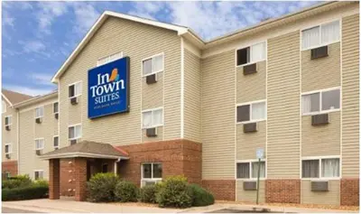 a hotel with a sign on the side of a building at InTown Suites Extended Stay Denver - Englewood in Englewood