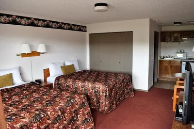 a hotel room with two beds and a kitchen at Littletree Inn in Granby