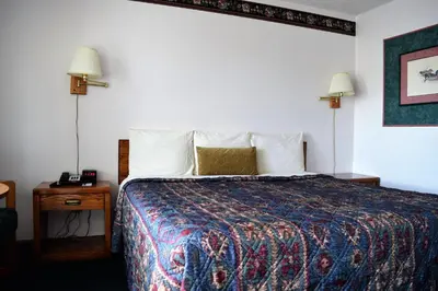 a hotel room with a bed and two lamps at Littletree Inn in Granby