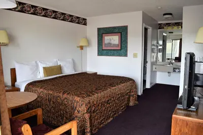 a hotel room with a bed and a television at Littletree Inn in Granby