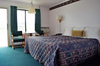 a hotel room with a bed and a table and chairs at Littletree Inn in Granby