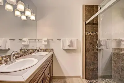 a bathroom with two sinks and a shower at 732B Meadow Creek Townhouse in Frisco