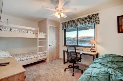 a bedroom with a desk and a bed and a window at 732B Meadow Creek Townhouse in Frisco