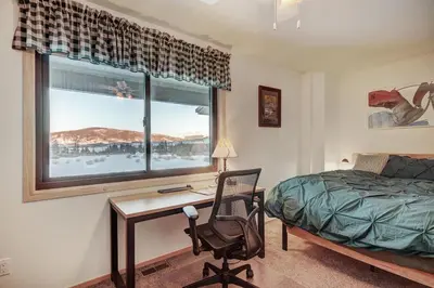 a bedroom with a desk and a bed and a window at 732B Meadow Creek Townhouse in Frisco