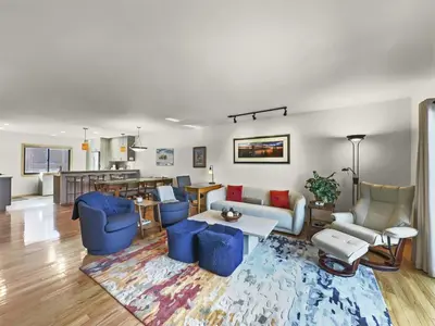 a living room with blue furniture and a kitchen at 732B Meadow Creek Townhouse in Frisco