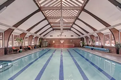 an indoor swimming pool with a large ceiling at 732B Meadow Creek Townhouse in Frisco