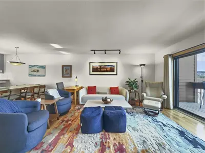 a living room with blue chairs and a table at 732B Meadow Creek Townhouse in Frisco