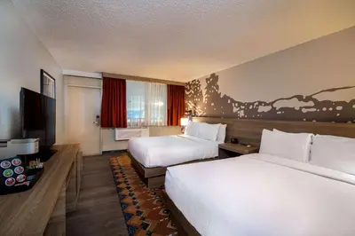 a hotel room with two beds and a television at Holiday Inn Estes Park by IHG in Estes Park
