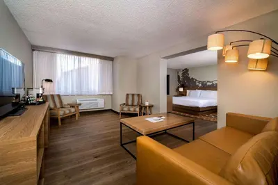 a living room with a couch and a bed at Holiday Inn Estes Park by IHG in Estes Park