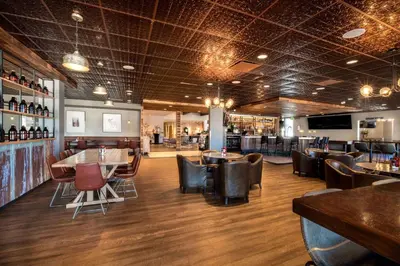 a restaurant with tables and chairs and a bar at Holiday Inn Estes Park by IHG in Estes Park