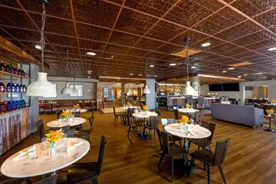 a restaurant with tables and chairs and a bar at Holiday Inn Estes Park by IHG in Estes Park