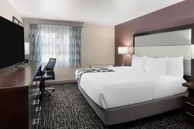 a hotel room with a large bed and a desk at La Quinta Inn & Suites by Wyndham Fort Collins, Colorado in Fort Collins