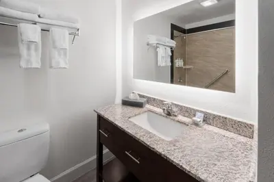 a bathroom with a sink and a mirror at La Quinta Inn & Suites by Wyndham Fort Collins, Colorado in Fort Collins