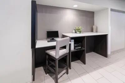 an office with a desk with a computer and a chair at La Quinta Inn & Suites by Wyndham Fort Collins, Colorado in Fort Collins