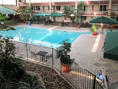 a large swimming pool in a hotel building at Clarion Inn in Fort Collins