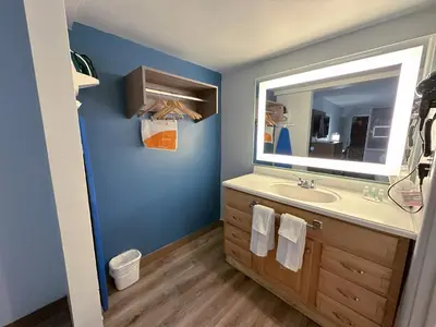 a bathroom with a sink and a mirror at Clarion Inn in Fort Collins
