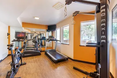 a gym with two treadmills and two exercise bikes at Best Western Kiva Inn in Fort Collins