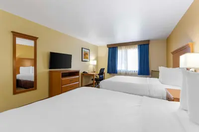 a hotel room with two beds and a television at Best Western Kiva Inn in Fort Collins