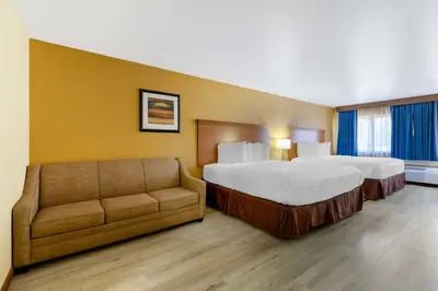 a hotel room with two beds and a couch at Best Western Kiva Inn in Fort Collins