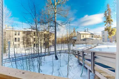 a balcony with a view of a snow covered yard at Lodgepole Landing in Silverthorne