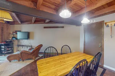a dining room with a wooden table and chairs at Lodgepole Landing in Silverthorne
