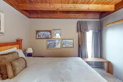 a bedroom with a large bed and a window at Lodgepole Landing in Silverthorne
